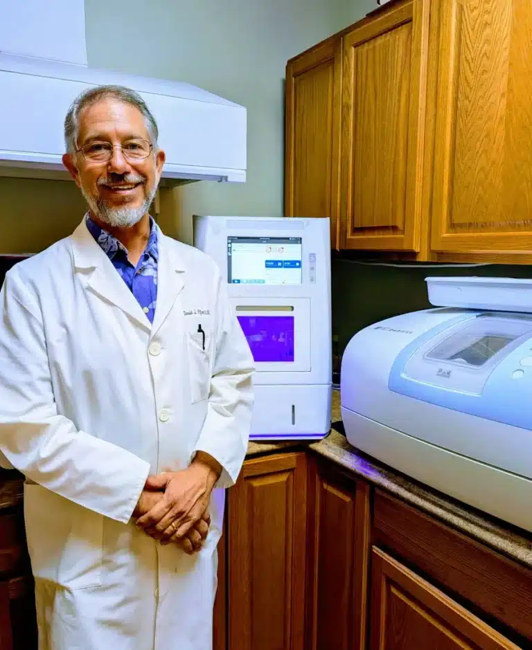 Dr. David Pfent of North Pointe Dental Center beside in-office dental equipment in North Fort Myers